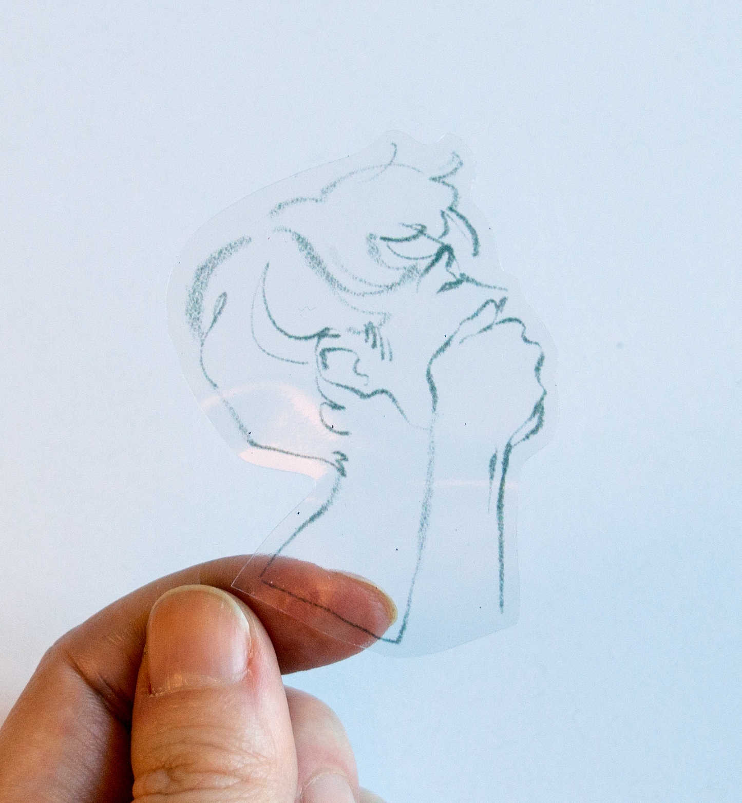 The transparent sticker sheet of a collection of small pencil illustrations from the Kinktober zine.